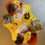 children with scarves coloring at table