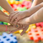 children's hands clasped